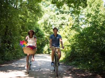 young-man-beautiful-african-american-girl-enjoying-bike-ride-nature-sunny-summer-day_530697-55029